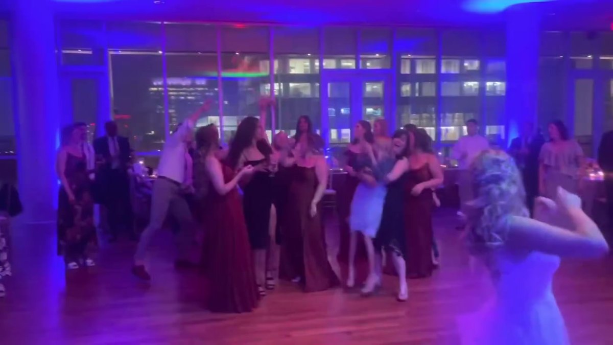 April & Andrew's wedding: blue uplighting over the dance floor and the uptown skyline