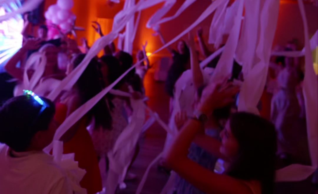 Streamers flying over the dance floor from a toilet paper shooter