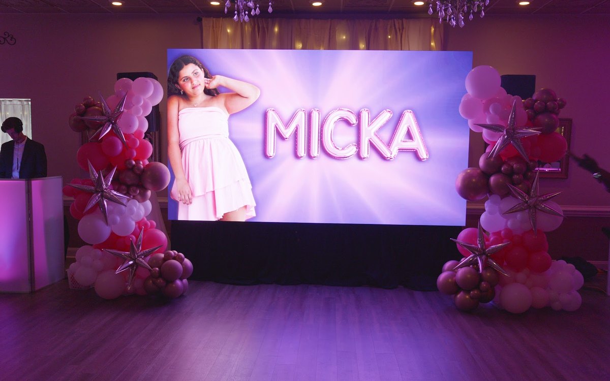 Pink and purple ATG uplighting, video wall and DJ facades at South Charlotte Banquet Center