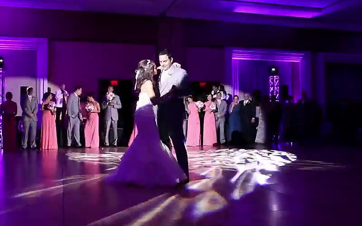 A first dance under purple ATG uplighting and a monogram light at The Westin Charlotte