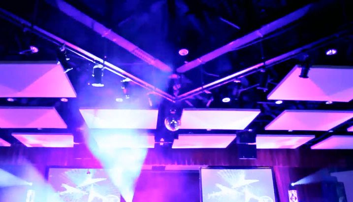 Corporate stage with LED screens and moving lights over an audience
